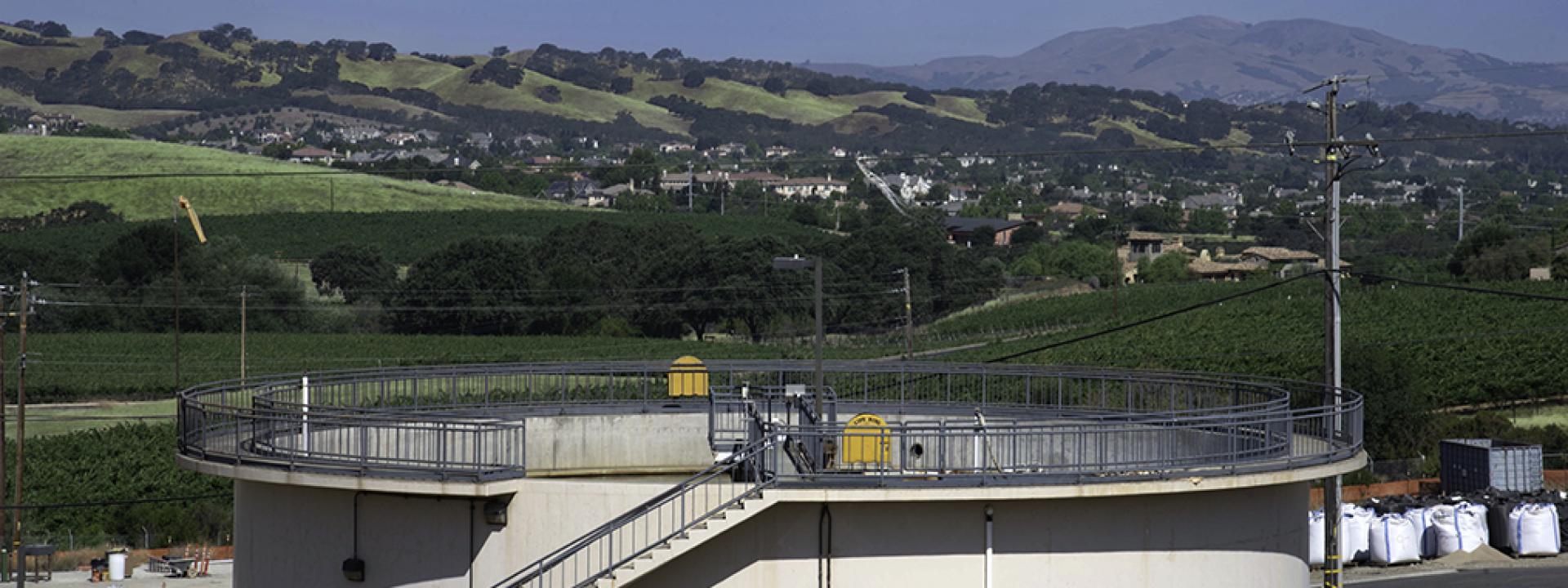 Water reservoir with green hills in the distance