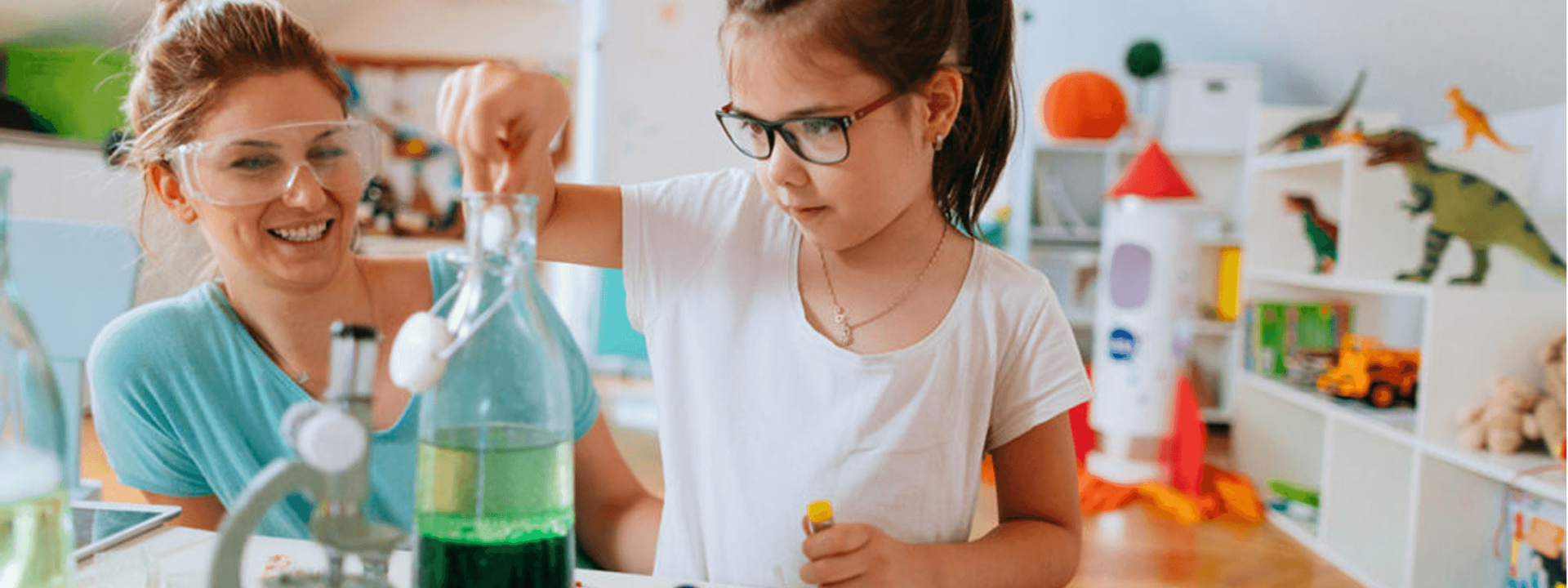 Child learning about water with her parent