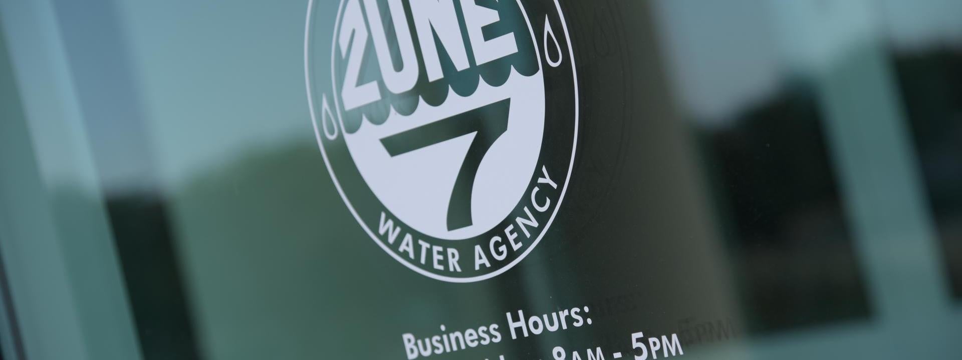 The window welcoming guests to Zone 7 headquarters, Business Hours: Monday through Friday, 8am - 5pm, For emergency call 925-447-6704