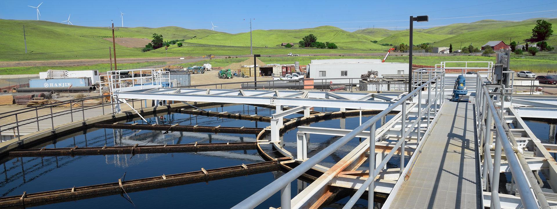 Photo of a large body of water with water treatment equipment along the surface