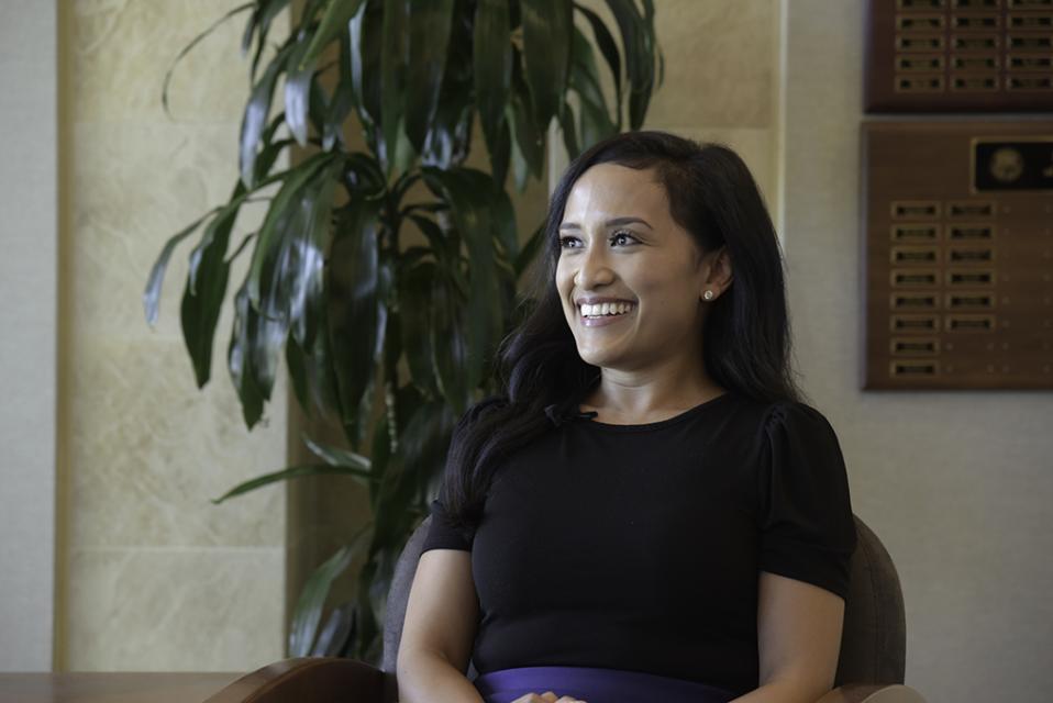 Zone 7 Employee smiling and sitting in a chair