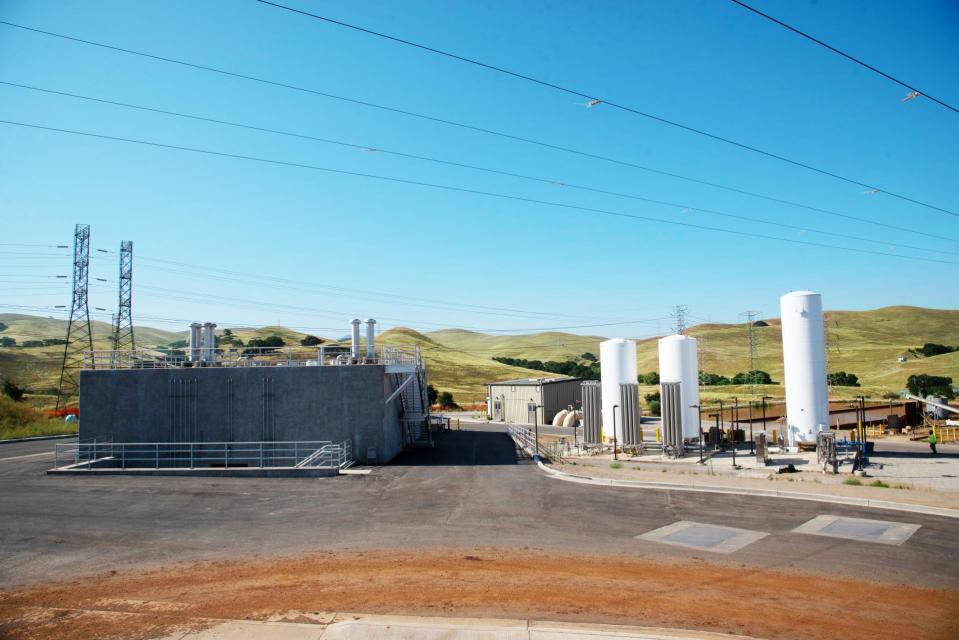 Water treatment facility with low building on the left and liquid oxygen tanks on the right.