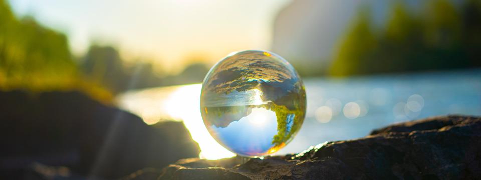 Light shining through a clear marble and reflecting the surround environment.