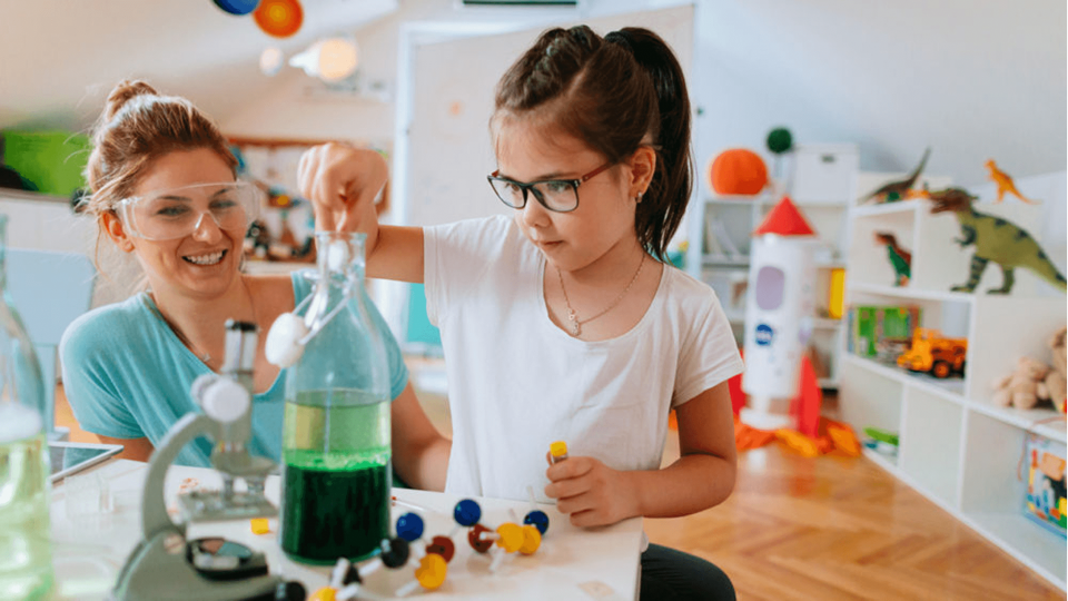 Child learning about water with her parent