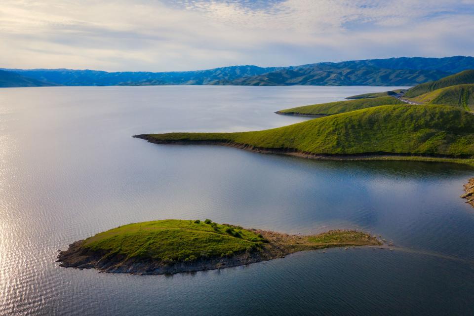 Aerial view of San Luis Reservoir with mountains surrounding the reservoir