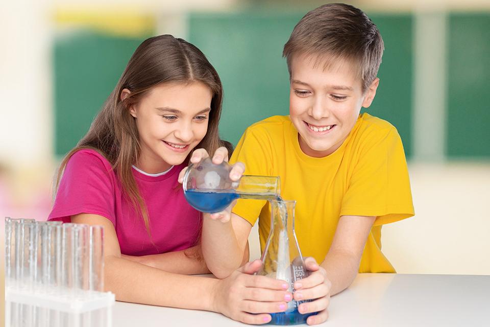 Two students working together in a classroom during a water activity