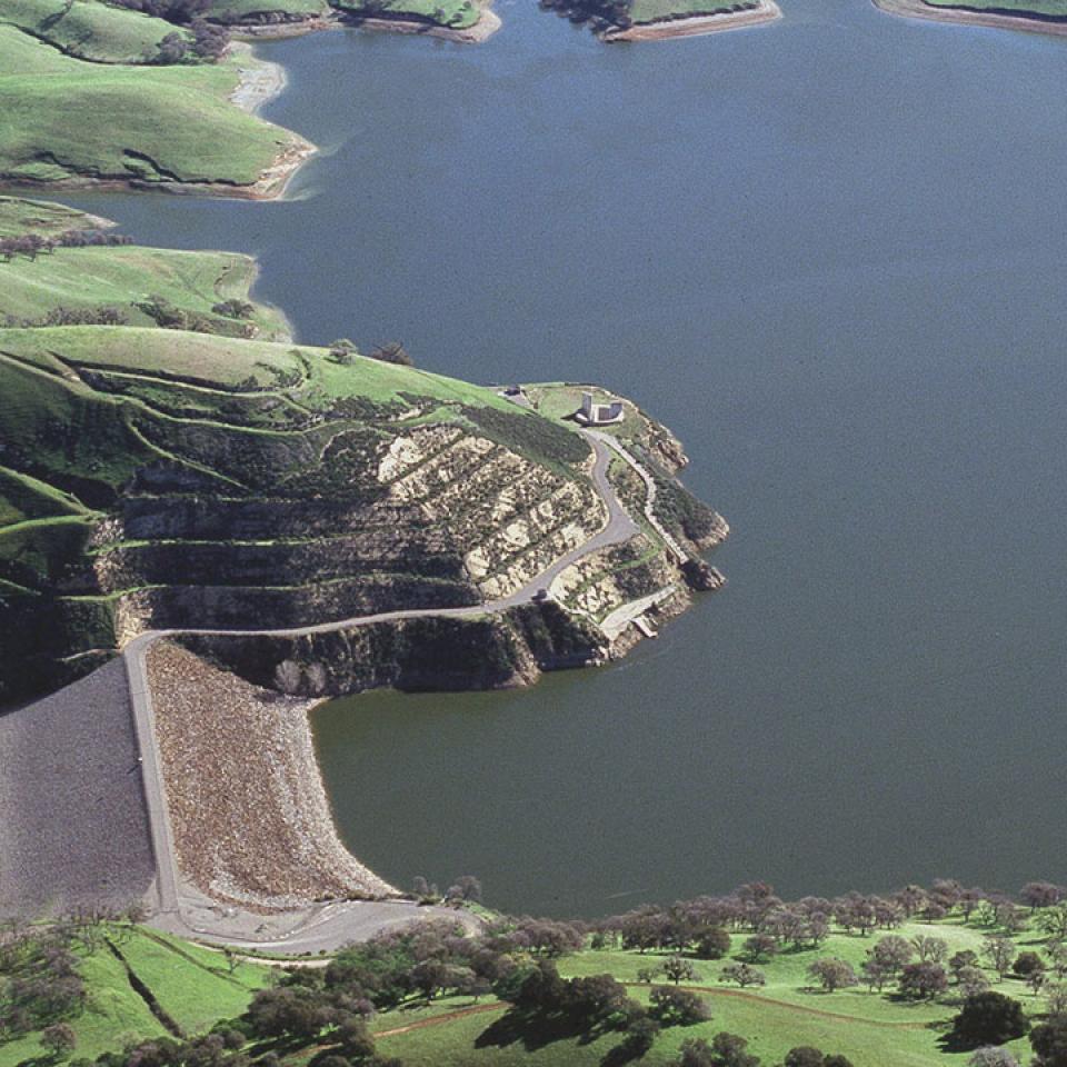 Dark blue lake in the middle of green hills and ridges