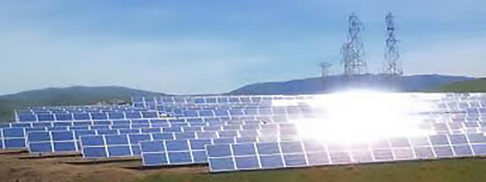 Rows of solar panels reflecting sunlight.